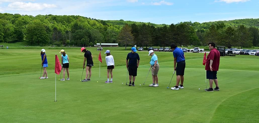 People learning how to play golf